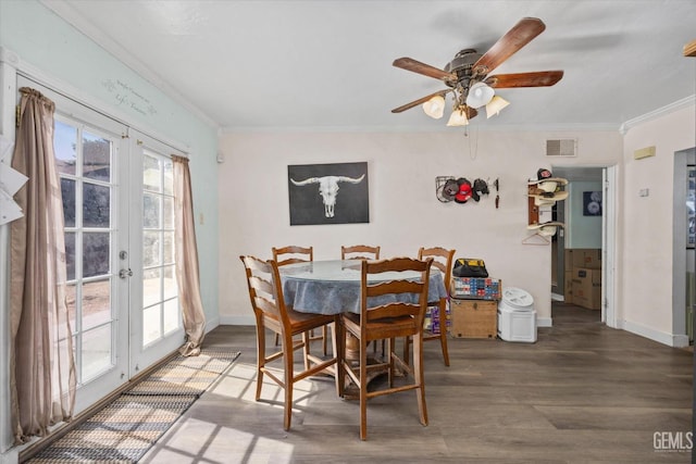 dining room with french doors, hardwood / wood-style flooring, ceiling fan, and crown molding