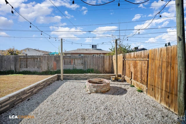 view of yard featuring an outdoor fire pit