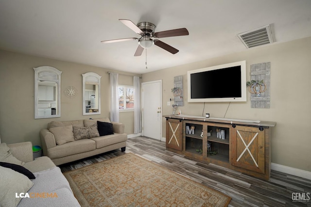 living room with hardwood / wood-style floors and ceiling fan