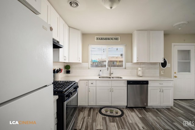 kitchen featuring white cabinetry, sink, decorative backsplash, and stainless steel appliances