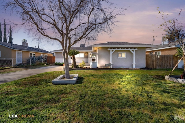 ranch-style home featuring a yard