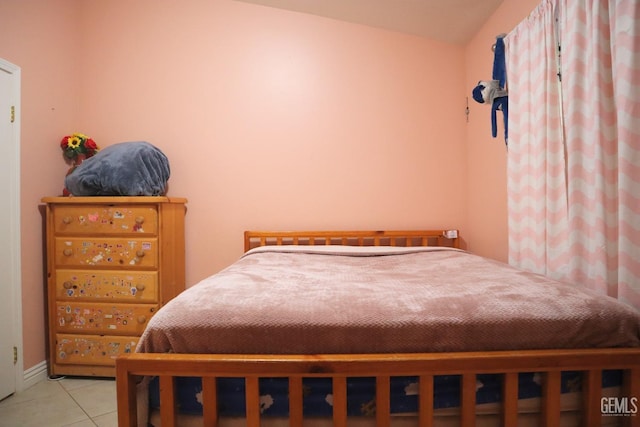 bedroom featuring vaulted ceiling and light tile patterned flooring