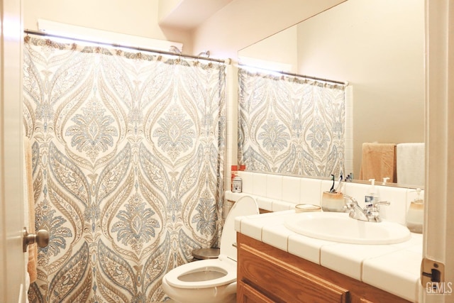 bathroom with vanity, toilet, and a shower with shower curtain