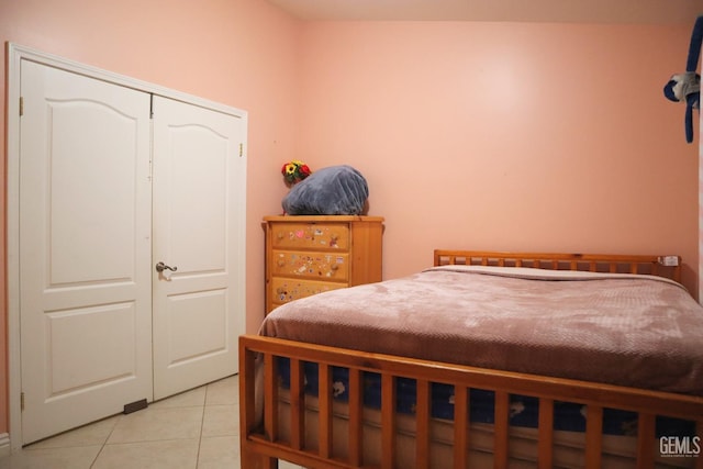 tiled bedroom with a closet