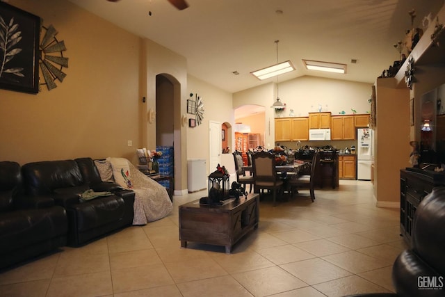 living room featuring ceiling fan, high vaulted ceiling, and light tile patterned floors