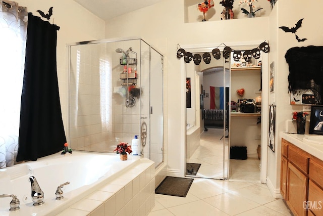 bathroom featuring vanity, tile patterned floors, and shower with separate bathtub