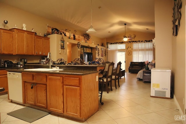 kitchen featuring a kitchen island, a breakfast bar, dishwasher, sink, and hanging light fixtures