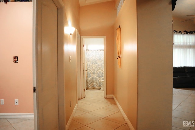 hall featuring light tile patterned flooring