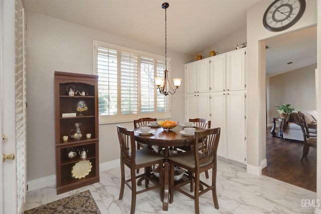 dining room featuring lofted ceiling and a chandelier