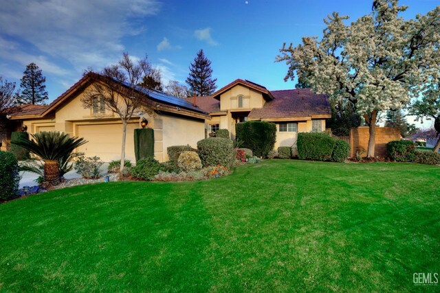 view of front of property with a garage and a front yard