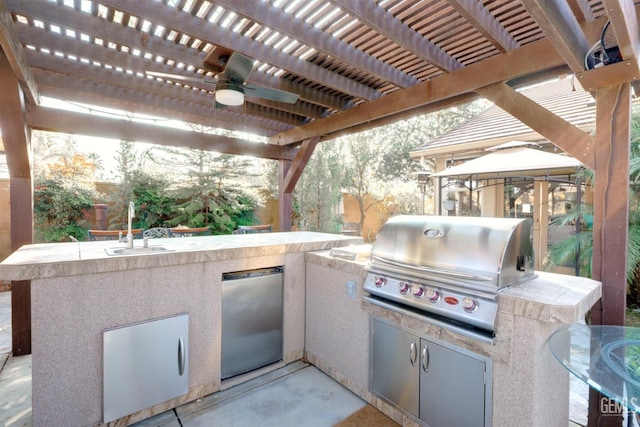 view of patio featuring sink, a pergola, a gazebo, a grill, and an outdoor kitchen