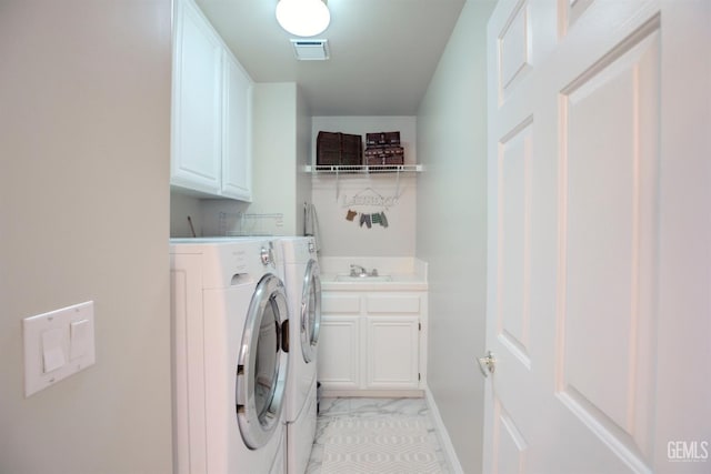 laundry area with independent washer and dryer, cabinets, and sink