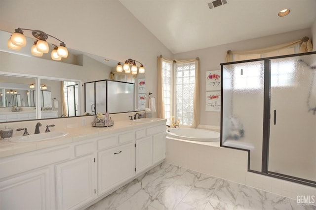 bathroom featuring independent shower and bath, vanity, and lofted ceiling