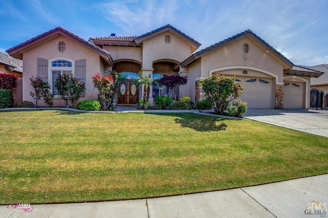 mediterranean / spanish-style home with a garage and a front yard