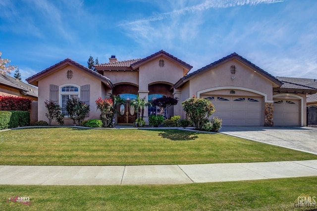 mediterranean / spanish-style home with a front lawn and a garage