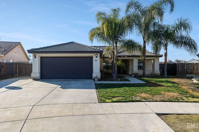 view of front of home featuring a garage and a front lawn