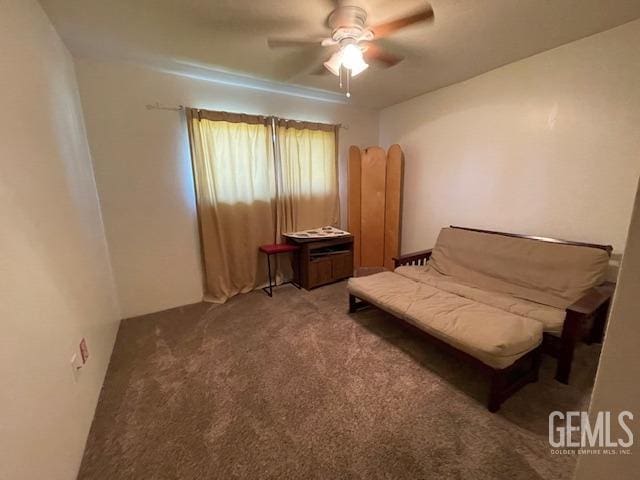 sitting room with ceiling fan and carpet floors