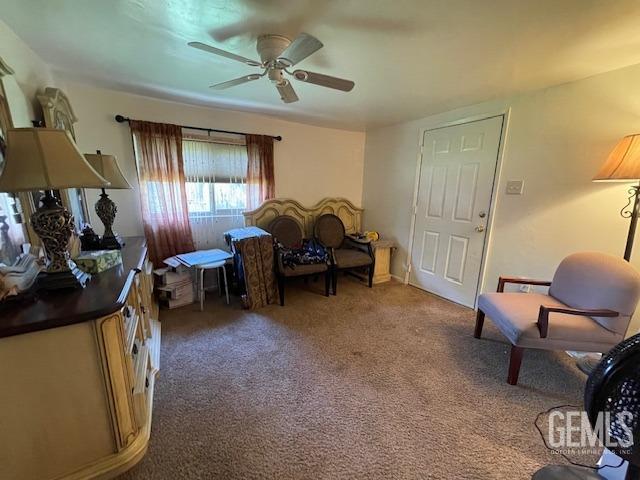 sitting room with carpet flooring and ceiling fan