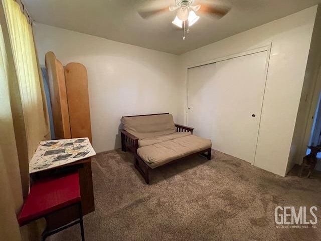 sitting room with carpet and ceiling fan