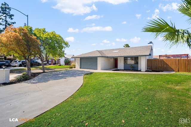 ranch-style home with a front lawn, fence, concrete driveway, an attached garage, and brick siding