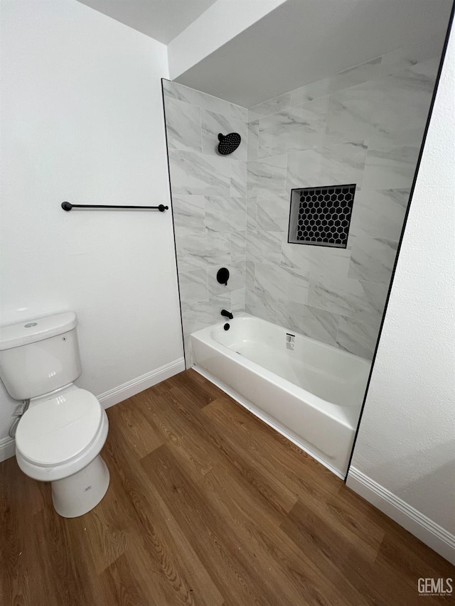 full bathroom featuring baseboards, toilet,  shower combination, and wood finished floors