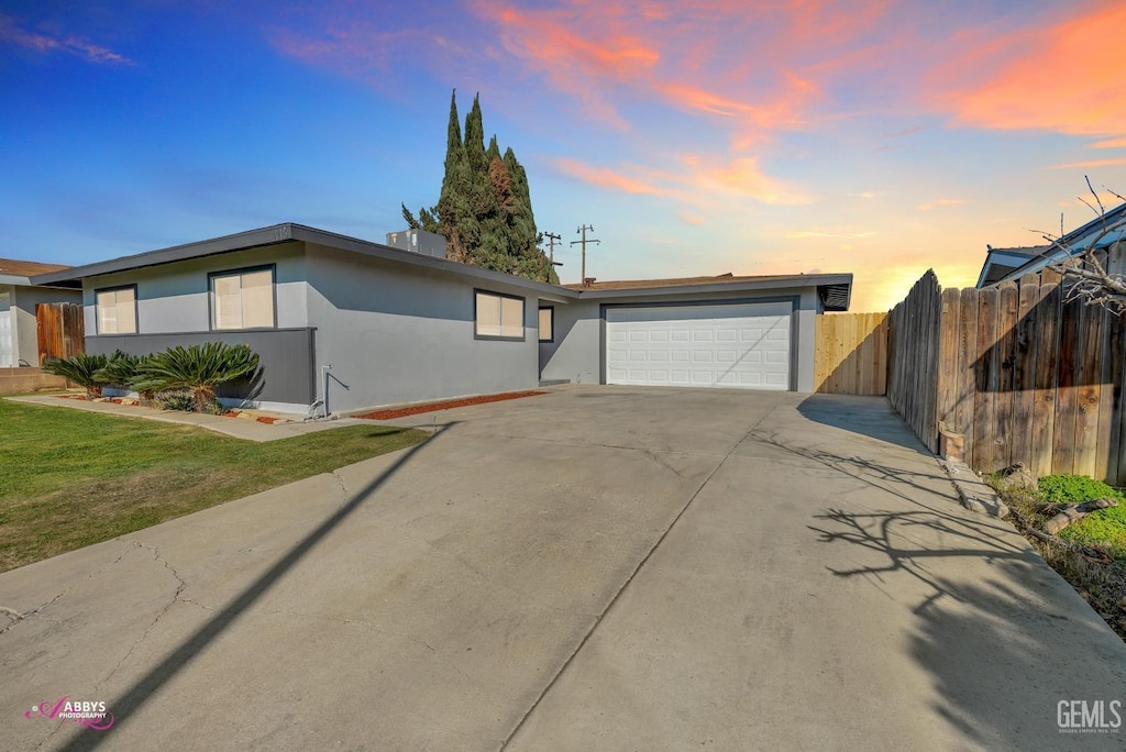 view of front facade with a garage and a lawn