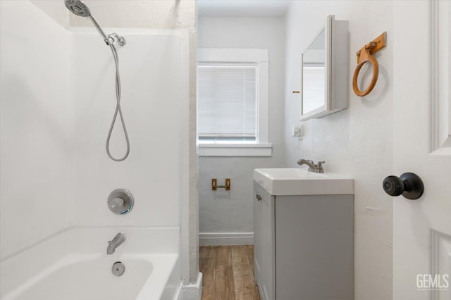 714 R St, Bakersfield, CA 93304 - bathroom featuring vanity, wood finished floors, and bathing tub / shower combination