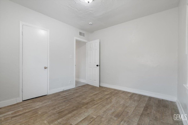 714 R St, Bakersfield, CA 93304 - unfurnished bedroom featuring wood finished floors and baseboards