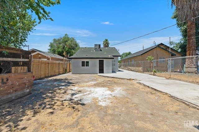 714 R St, Bakersfield, CA 93304 - back of house featuring stucco siding and a patio