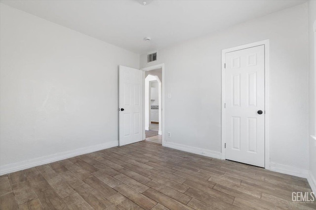 714 R St, Bakersfield, CA 93304 - unfurnished bedroom featuring wood finished floors and arched walkways