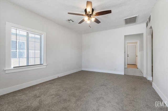 714 R St, Bakersfield, CA 93304 - empty room featuring light colored carpet, ceiling fan, and a textured ceiling