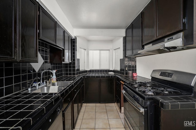 764 E Sutter Ave, Earlimart, CA 93219 - kitchen with stainless steel range with gas stovetop, under cabinet range hood, decorative backsplash, light tile patterned floors, and dark cabinets