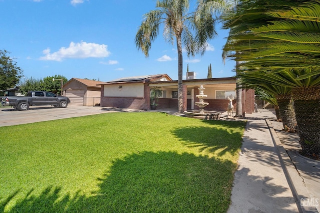 764 E Sutter Ave, Earlimart, CA 93219 - single story home with a front yard, solar panels, stucco siding, and brick siding