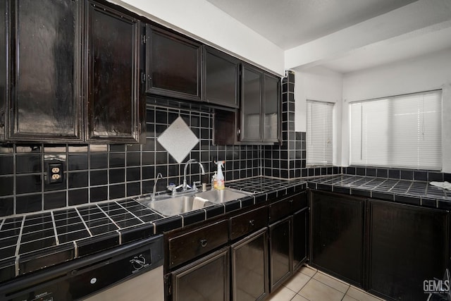 764 E Sutter Ave, Earlimart, CA 93219 - kitchen with dishwashing machine, tile countertops, decorative backsplash, and light tile patterned floors