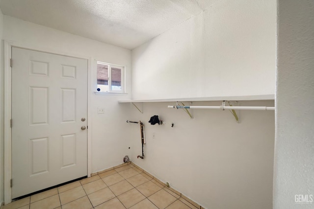 764 E Sutter Ave, Earlimart, CA 93219 - laundry room featuring a textured ceiling and light tile patterned flooring