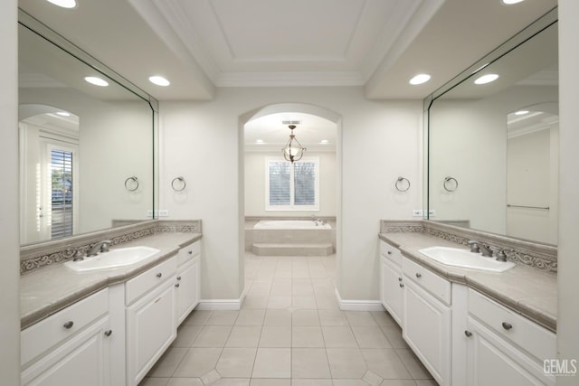 bathroom featuring tile patterned flooring, a sink, a bath, and crown molding