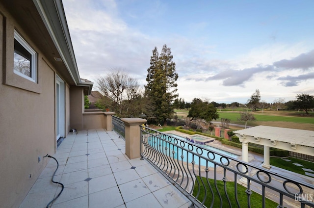 balcony with a pool with connected hot tub