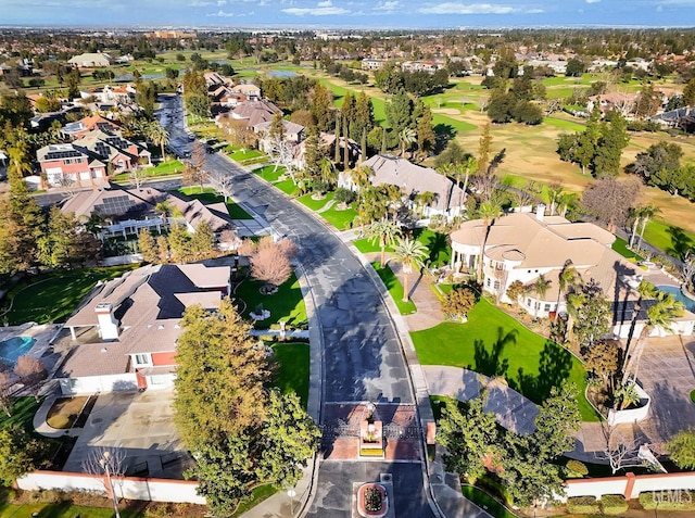 aerial view with golf course view and a residential view