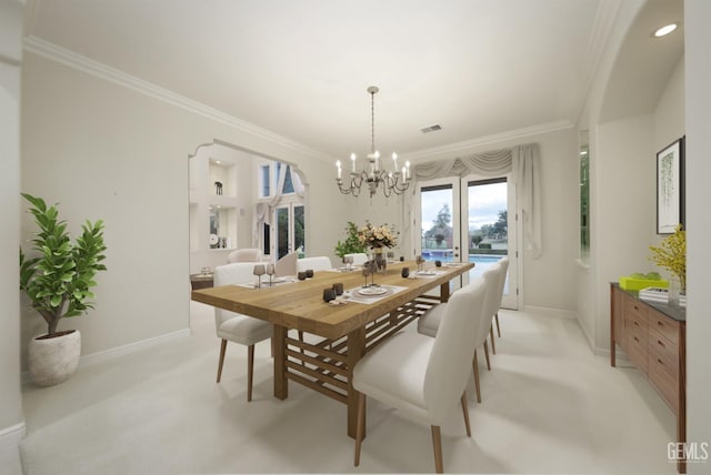 dining room featuring baseboards, ornamental molding, and a notable chandelier