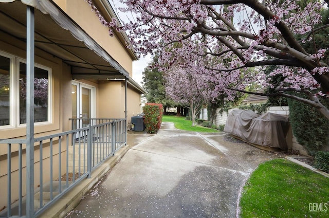 view of patio / terrace featuring fence and central AC