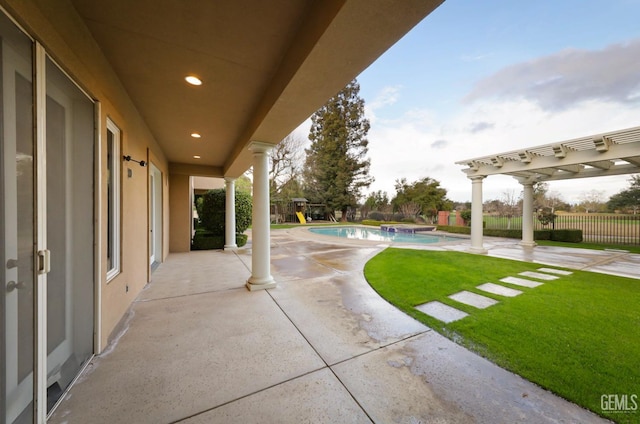 view of patio featuring fence, a fenced in pool, and a pergola