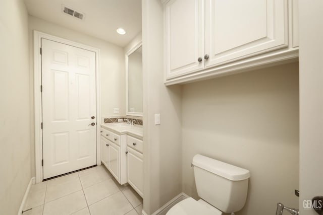 half bathroom with recessed lighting, visible vents, toilet, vanity, and tile patterned floors