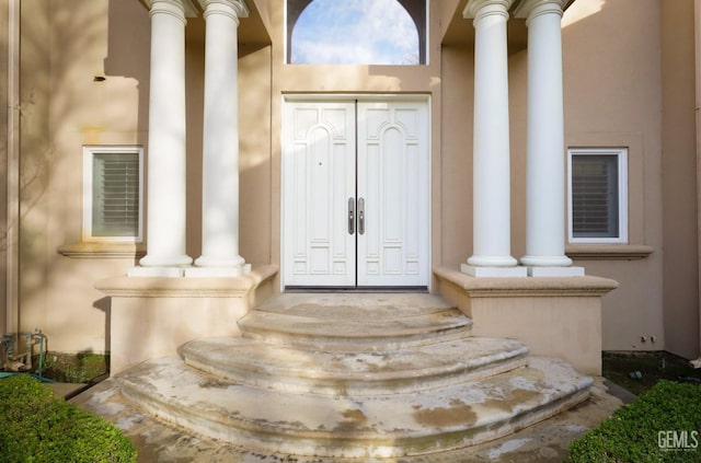 entrance to property featuring stucco siding