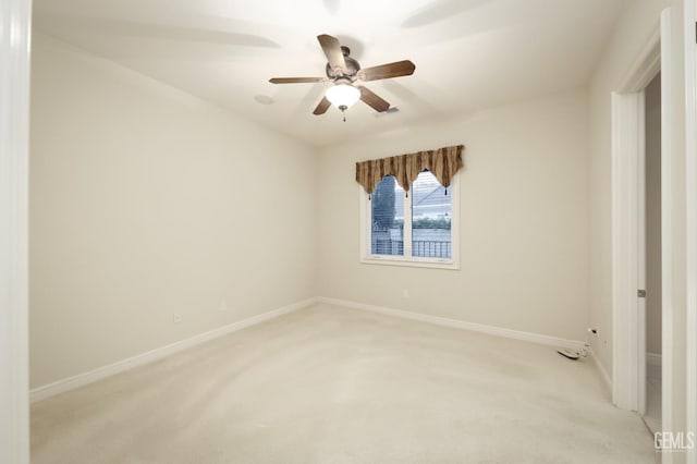 unfurnished room with light carpet, visible vents, a ceiling fan, and baseboards