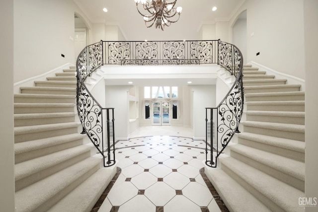 foyer entrance featuring recessed lighting, a notable chandelier, a high ceiling, baseboards, and ornamental molding