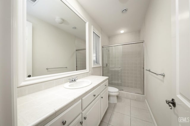 full bathroom with tile patterned flooring, toilet, vanity, baseboards, and a shower stall