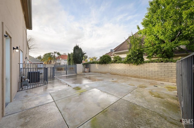 view of patio / terrace with central air condition unit and a fenced backyard