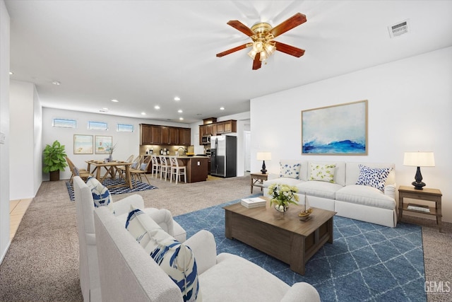 living room with dark colored carpet and ceiling fan