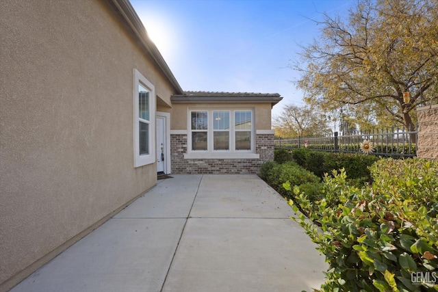 view of side of home with a patio area