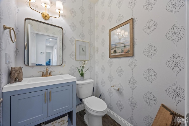 bathroom featuring wood finished floors, vanity, and toilet